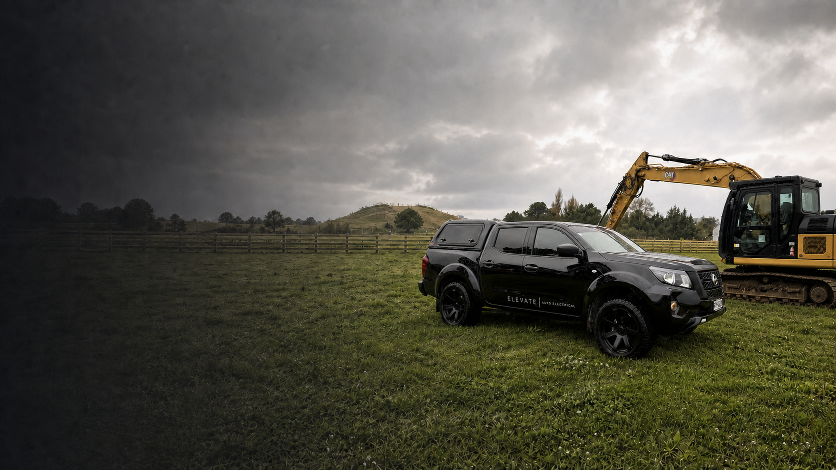 Black Elevate Auto Electrical Nissan Navara ute parked beside excavation machinery at a rural worksite